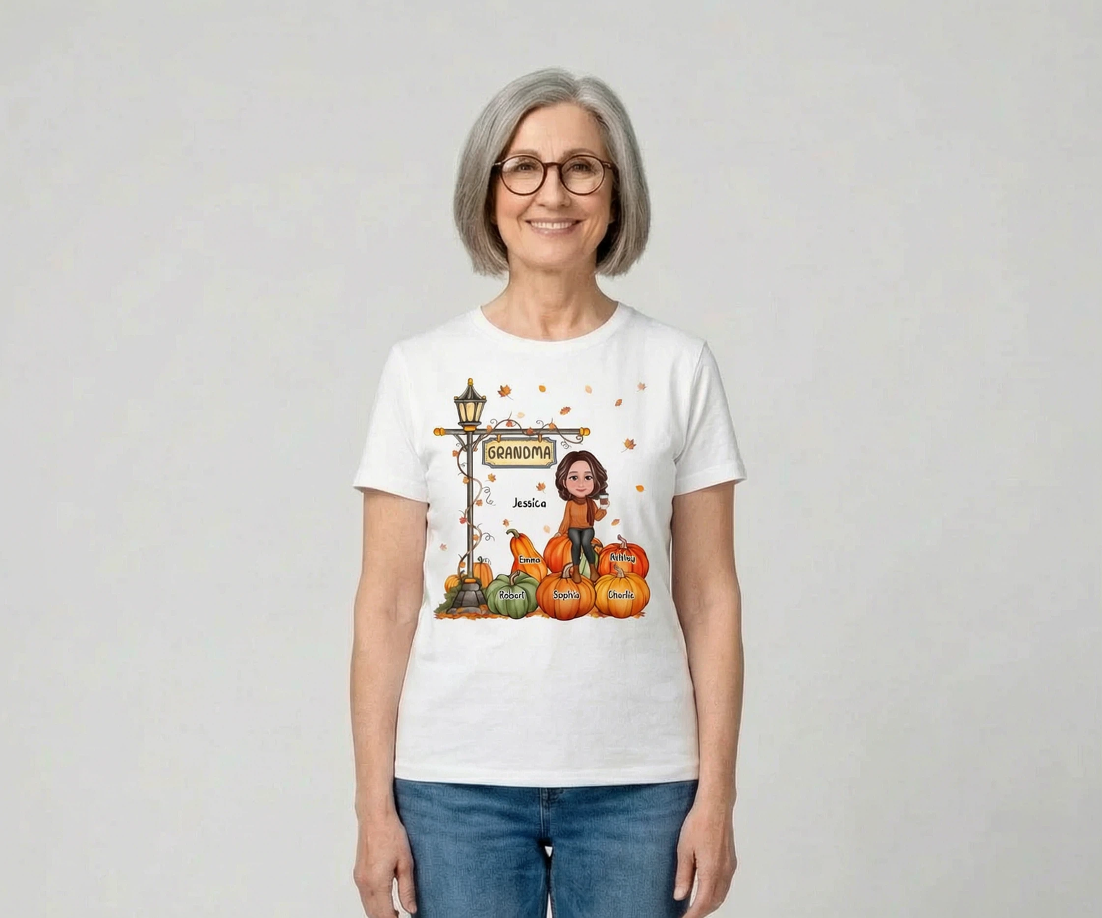 Grandma Mom Sitting On Pumpkin Under Lamp Post Fall Season Personalized Shirt — White